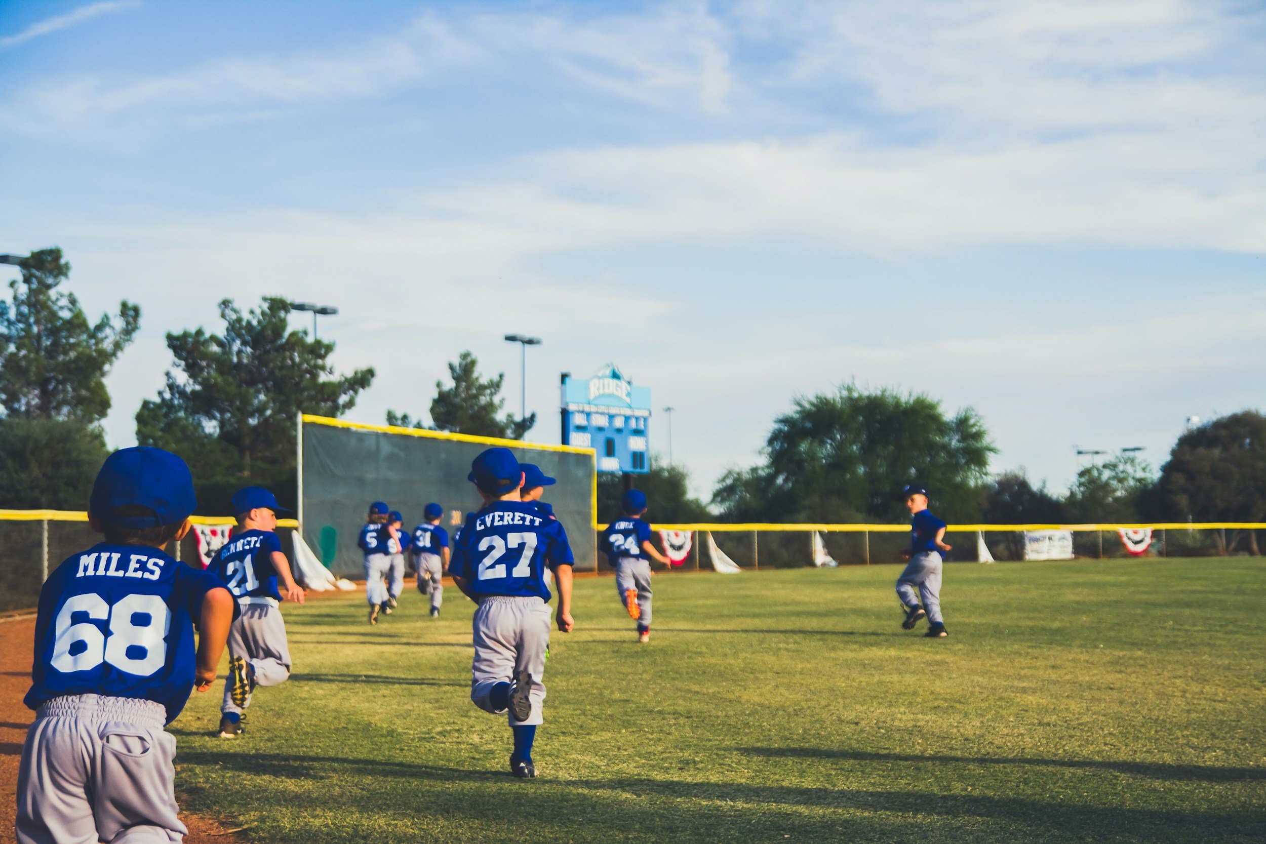 Baseball players walking together across the field